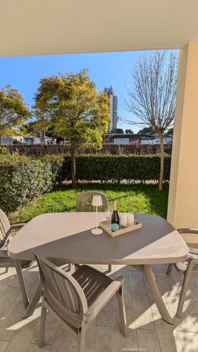 a white table and chairs with a view of a park at Mazzini Green Suites Jesolo in Lido di Jesolo