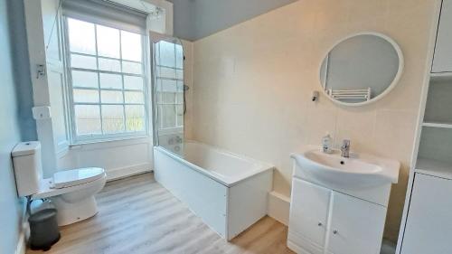 a white bathroom with a sink and a toilet at Spacious Victorian Apartment in Edinburgh City in Edinburgh