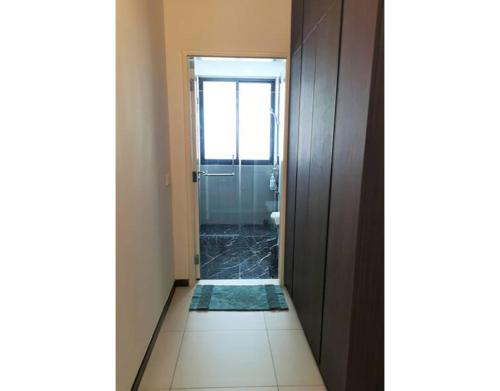 a hallway with a door leading to a bathroom at 皇家海景ROYAL Luxury Seaview Room, 3 minute to Gurney in Tanjong Tokong
