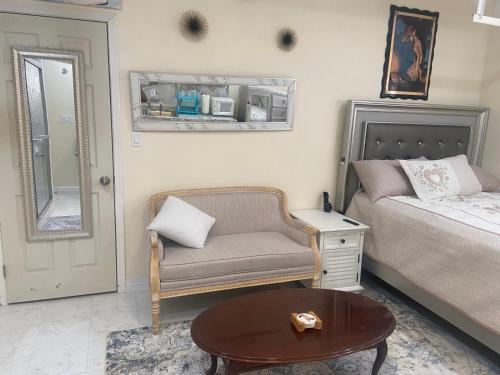 a bedroom with a bed and a chair and a table at Hidden Gem in Stevenson Ranch