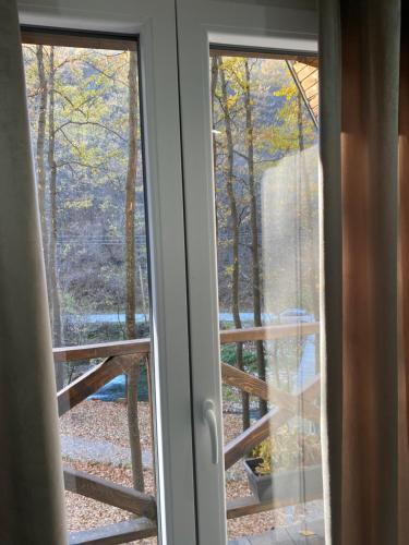 an open window with a view of the woods at Planinska vila KTM Lisine in Despotovac