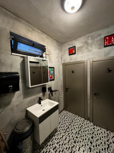 a bathroom with a sink and a toilet at Nomad Hostel Karaköy in Istanbul