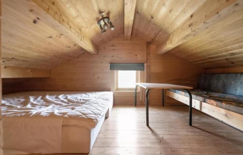 a bedroom with a bed and a table in a room at Stunning Home In Vinderup With Kitchen in Vinderup