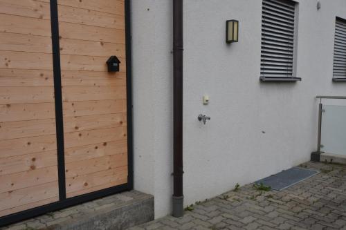 a pole next to a building with a wooden wall at Home Maislinger - Enjoy Nature, Explore Salzburg in Wals
