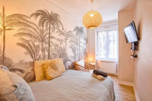 a bedroom with a bed with a stuffed animal on it at Le Tropical in Flers