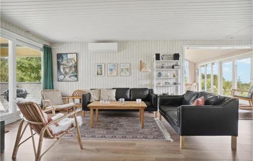 a living room with a black couch and a table at Three-Bedroom Holiday Home In Fur in Fur
