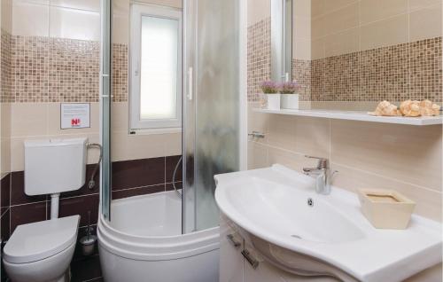 a bathroom with a toilet and a sink and a shower at Beautiful Home In Prigradica in Prigradica
