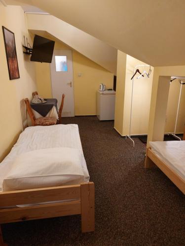 a bedroom with a bed and a tv in a room at Zajazd Ustronie in Piaseczno