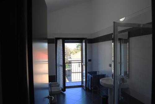 a bathroom with a sink and a glass door at Vintage Apartment in Caselle Torinese