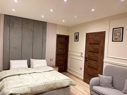 a bedroom with a bed and a chair at Rihana pyramids hotel in Cairo