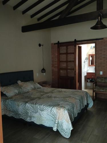 a bedroom with a large bed in a room at Finca MonteSer in Jardin