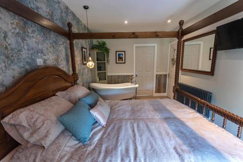 a bedroom with a large bed and a bath tub at Luxury retreat in Lincolnshire in Lincoln