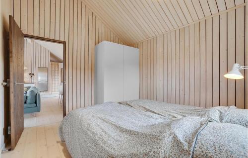 a bedroom with a bed and a mirror at 3 Bedroom Stunning Home In Thyholm in Thyholm
