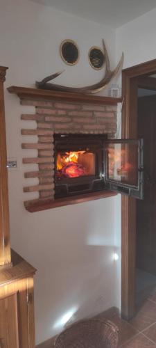 a fireplace in a room with a pizza oven at La Casa dei Nonni in Barrea