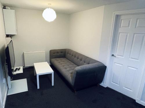 a living room with a couch and a table at Studio Flat in Angus