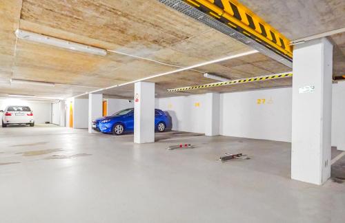a parking garage with two cars parked in it at Magic View Apartman Vyhlidka in Karlovy Vary