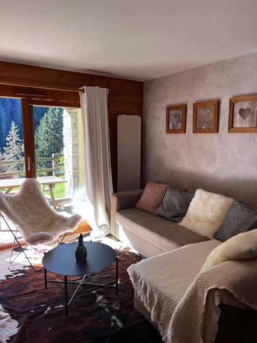 un salon avec un canapé et une table dans l'établissement L'OURSON 1er, à Cohennoz