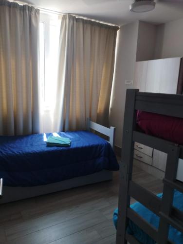 a bedroom with a bed and a ladder and a window at Departamento Temporario San Pedro in San Pedro