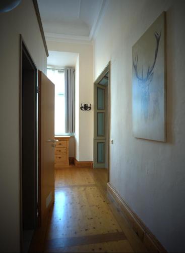 a hallway with a picture of a deer on the wall at Schloss Oppurg in Oppurg