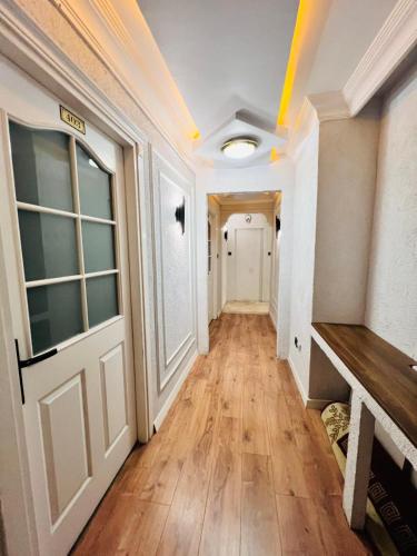 a hallway of a home with a door and wooden floors at Pembe Köşk Old City Center in Istanbul