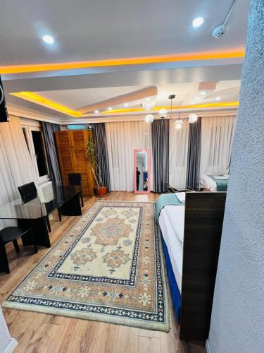 a bedroom with a bed and a rug at Pembe Köşk Old City Center in Istanbul