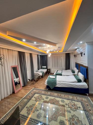 a bedroom with a king sized bed and a rug at Pembe Köşk Old City Center in Istanbul