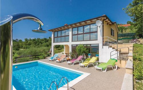 a house with a swimming pool in front of a house at Awesome Home In Meloni With Sauna in Karojba