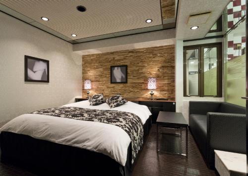 En eller flere senge i et værelse på HOTEL FIVE -Adult Only-