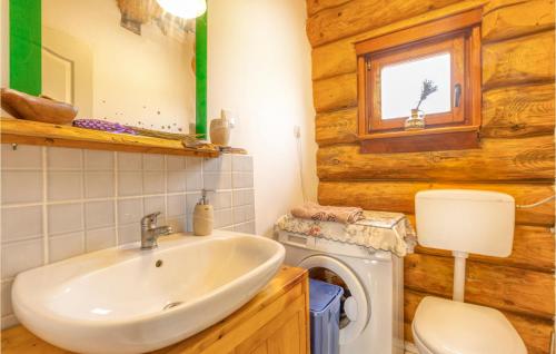 a bathroom with a sink and a washing machine at Beautiful Home In Sveti Rok in Sveti Rok