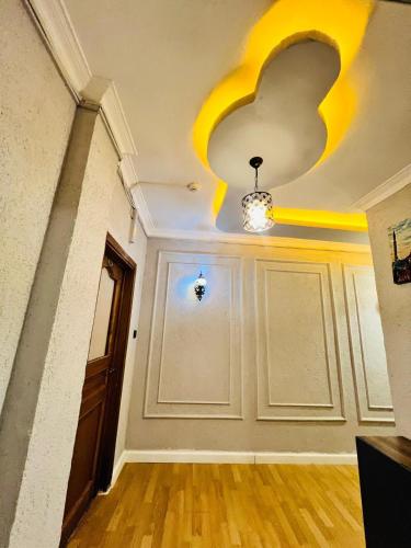 a room with a door and a ceiling with yellow paint at Pembe Köşk Old City Center in Istanbul