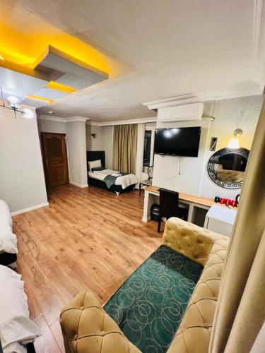 a living room with a couch and a desk in a room at Pembe Köşk Old City Center in Istanbul