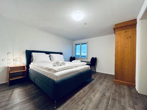a bedroom with a large bed and a window at Private room with Bathroom and Lake View in Guest House in Heiden