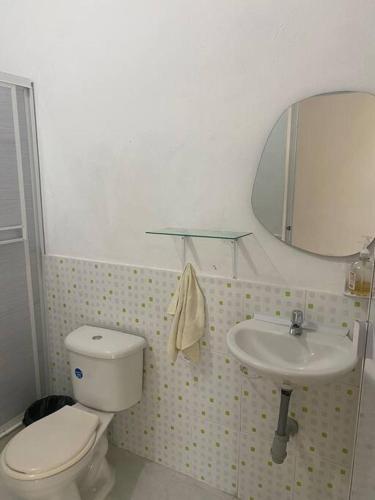 a bathroom with a toilet and a sink at Finca Villa Rosita Guamal - Meta in Guamal