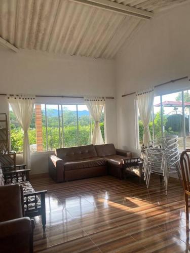 a living room with a couch and tables and chairs at Finca Villa Rosita Guamal - Meta in Guamal