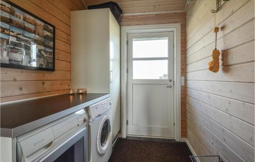 a laundry room with a washer and dryer at Stunning Home In Skjern With Kitchen in Lem