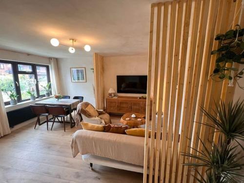 a living room with a couch and a table at A Cozy Home Away from Home in Leatherhead
