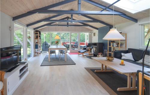 a living room with a table and a couch at Holiday Home Hurup Thy With Hot Tub I in Sønder Ydby