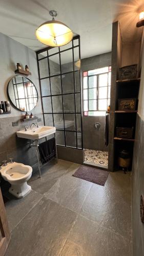 a bathroom with a toilet and a sink and a shower at Rancho Capilla in Capilla del Señor