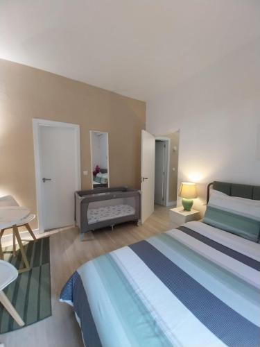 a bedroom with a bed and a table and a desk at Home 120, Mansion Alhamar in Sitio de Calahonda