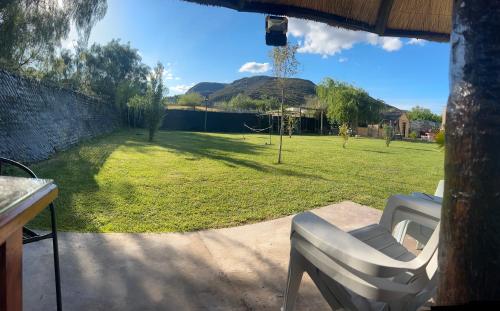 a view of a yard from a patio with a chair at BRISAS DEL VALLE San Rafael in Valle Grande