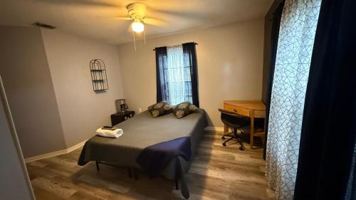 a bedroom with a bed and a desk in a room at Kris Jordan in Palm Bay