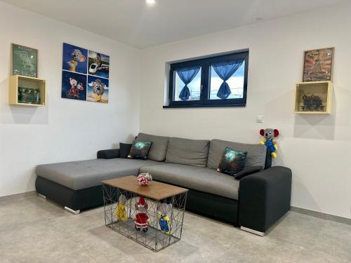 a living room with a couch and a table at Europ-Appart --- Europa-Park-Rulantica in Huttenheim