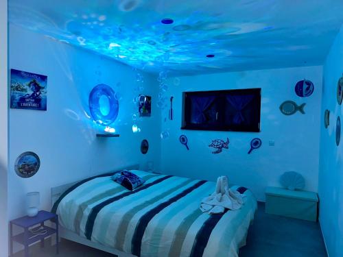 a bedroom with a bed with blue lights on the ceiling at Europ-Appart --- Europa-Park-Rulantica in Huttenheim