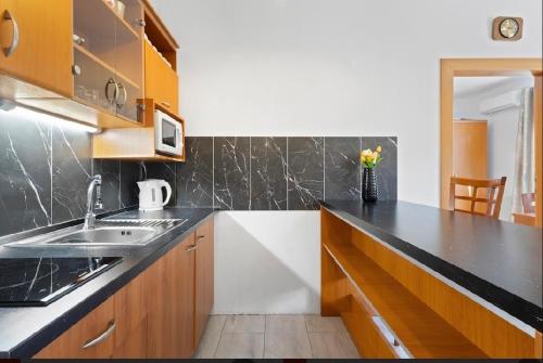 a kitchen with a sink and a counter top at Aura centrum in Piešťany