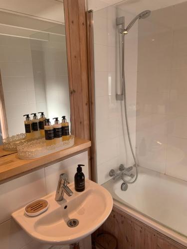 a bathroom with a sink and a shower and a tub at Stunning Rural Mill House nr beach and harbour in Banff