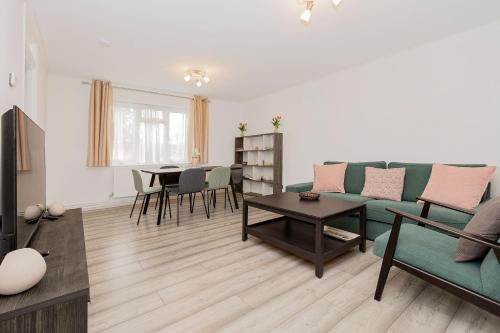 a living room with a couch and a table at 2BR with parking, Mill Hill, NW London, 10min Tube in Mill Hill