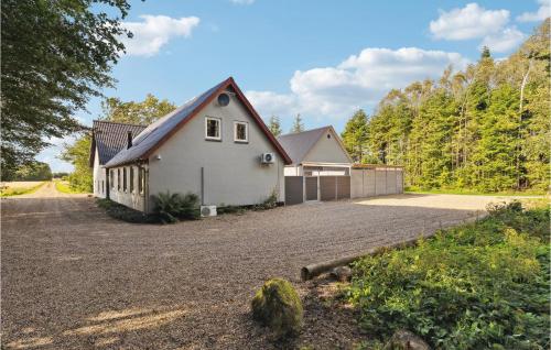 a white house with a driveway in front at 7 Bedroom Stunning Home In Sønder Omme in Sønder Omme
