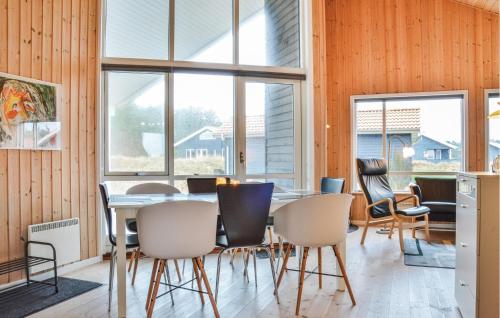 a dining room with a table and chairs at Three-Bedroom Holiday Home In Ulfborg in Fjand Gårde