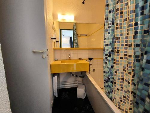 La salle de bains est pourvue d'un lavabo jaune et d'un miroir. dans l'établissement Résidence Le De 4 - Appartement 2 pièces pour 4 personnes de 25m² MAE-2311, à La Plagne Tarentaise