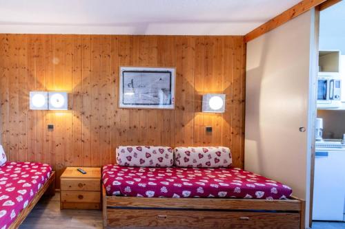 deux lits dans une chambre aux murs en bois dans l'établissement Résidence Le De 1 - Studio pour 3 personnes de 22m² MAE-0351, à La Plagne Tarentaise